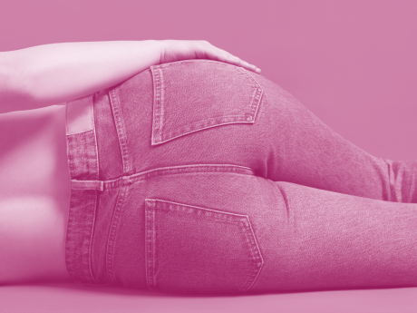 zoomed in view of woman wearing jeans laying on side 