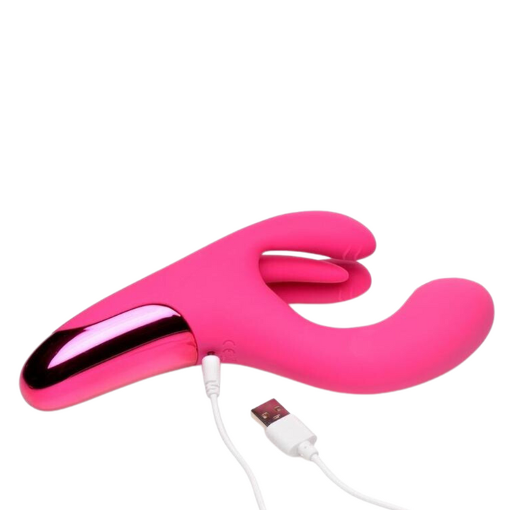 Side view of pink BANG! Triple Rabbit Silicone Vibrator with charging cable attached.