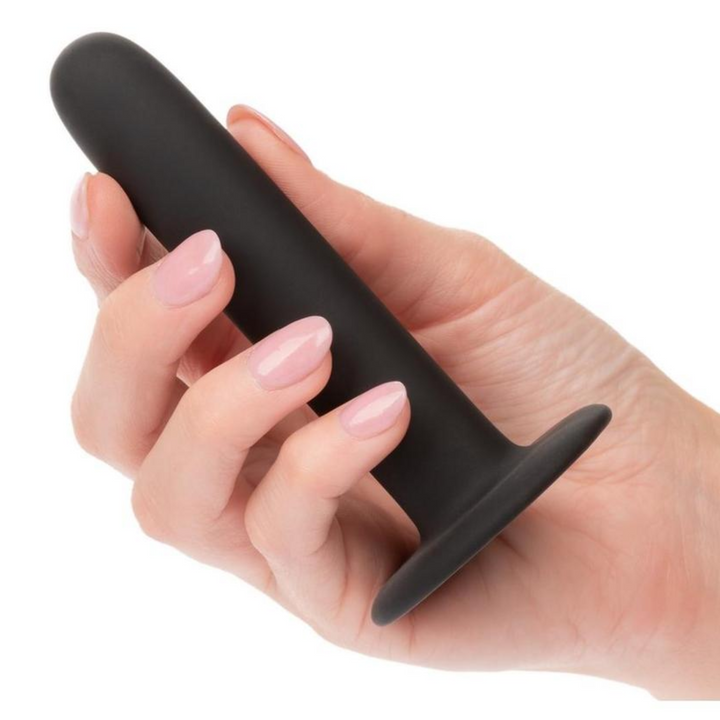 hand holding straight black anal probe 