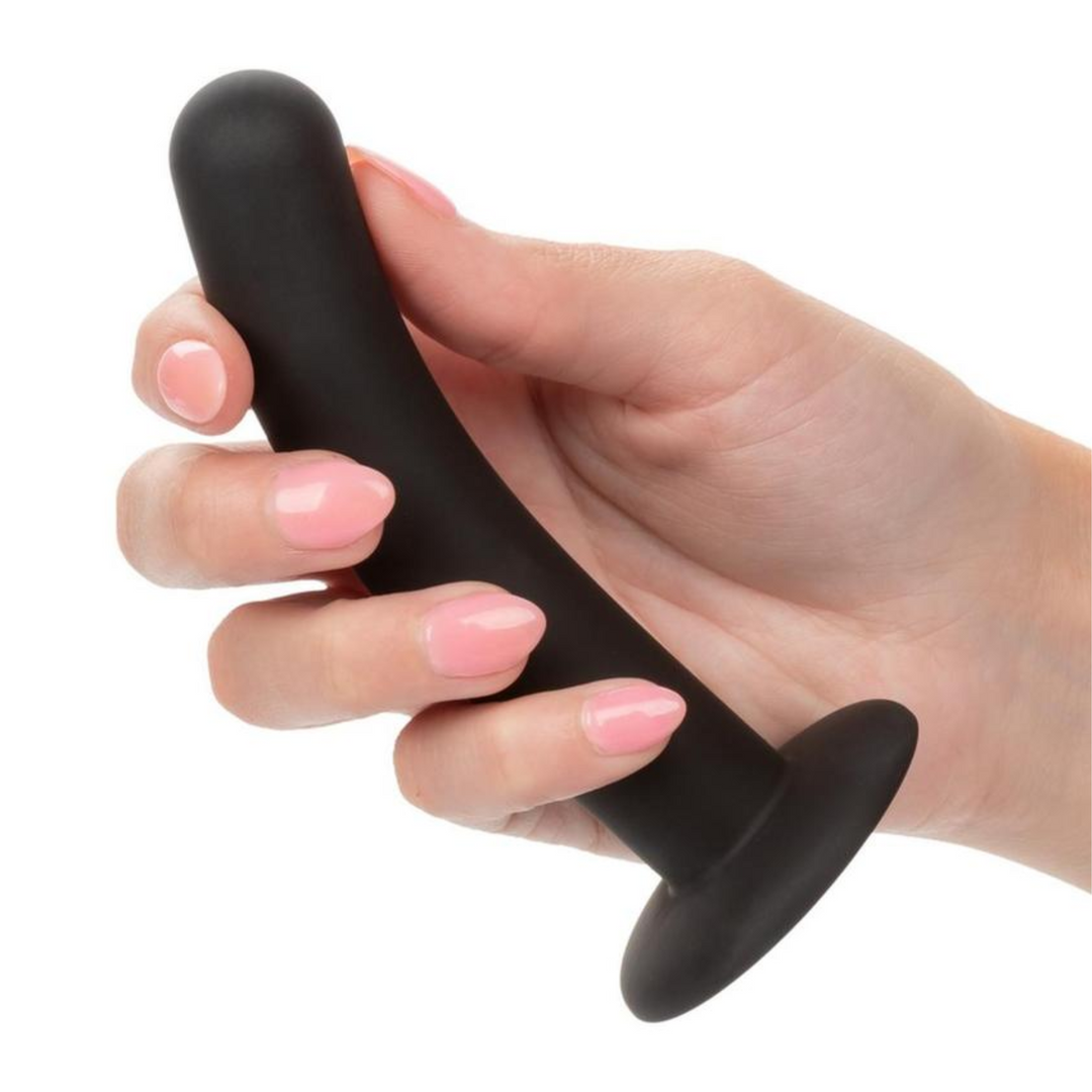 hand holding curved black anal probe 