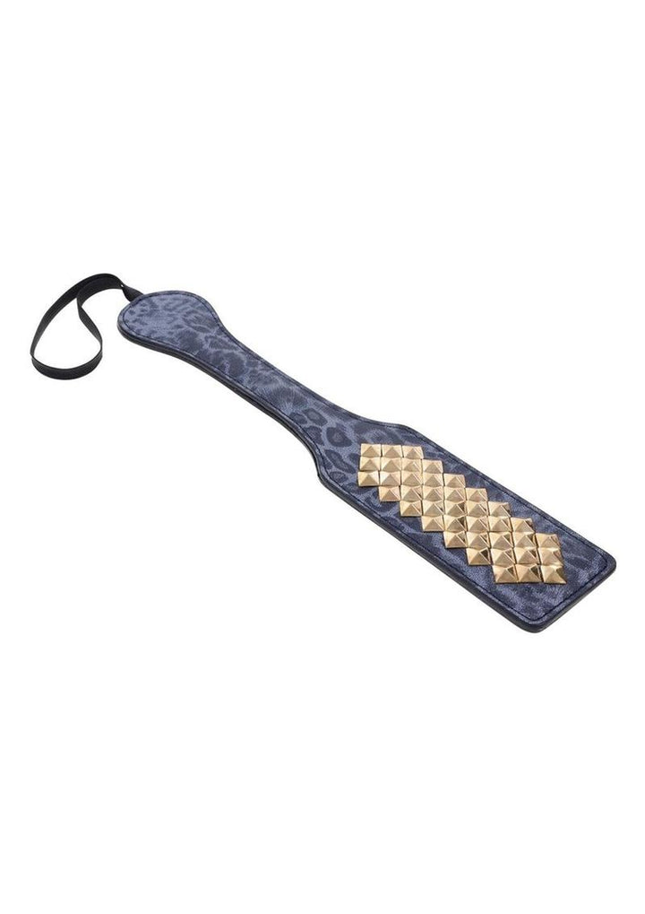 blue leopard leather paddle with gold studs laying flat