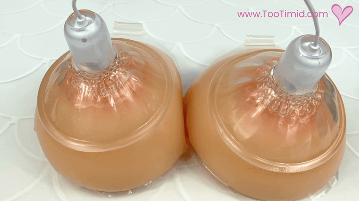 GIF of nipple suckers vibrating on a pair of model breasts