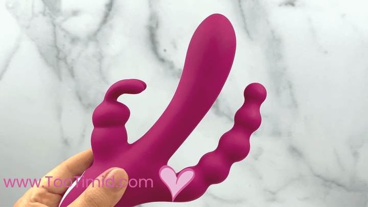 GIF of dark pink triple stimulator vibrating