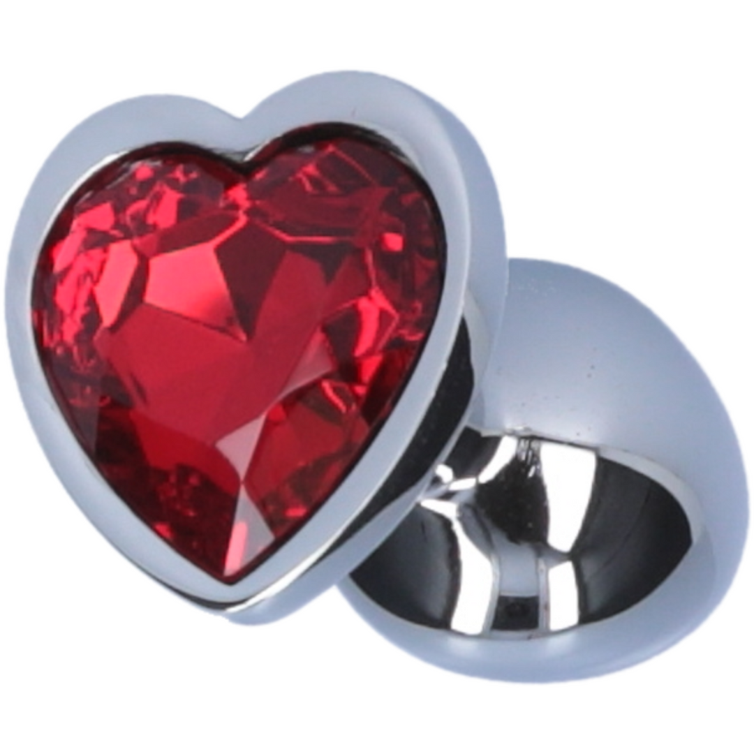 Image of butt plug laying on its side, showing the red heart jewel on the bottom.