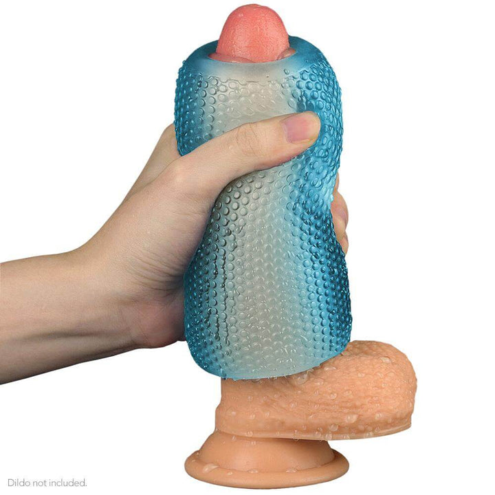 Blue masturbator being demonstrated on a dildo